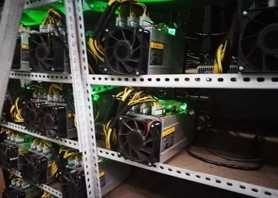 A vast cryptocurrency mining farm with rows of high-efficiency miners